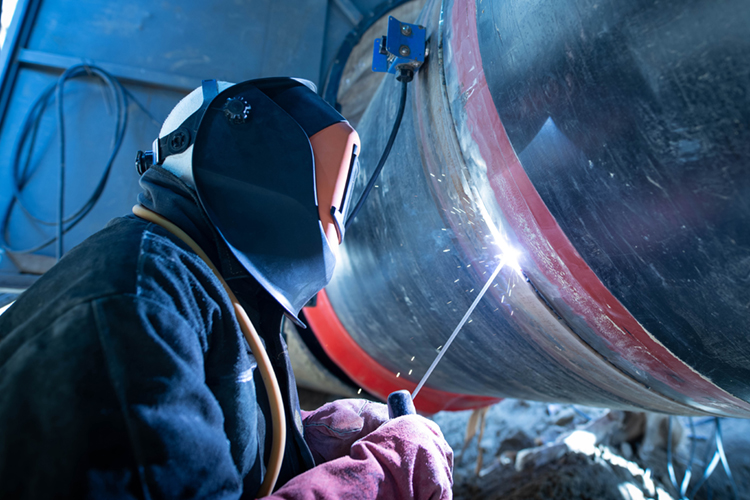 Welder in pipe construction.